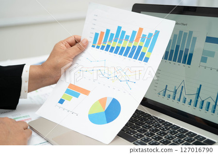 Asian business woman working with financial graph. 127016790