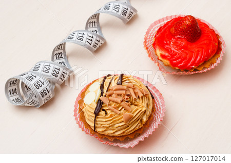 cupcakes with measuring tape on table 127017014
