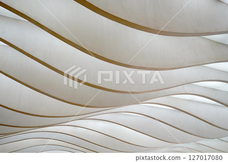 Wavy, layered panels create a dynamic, abstract pattern, playing with light and shadow. 127017080