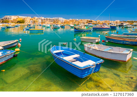 View of colorful fishing boats in Birzebbuga, Malta 127017360
