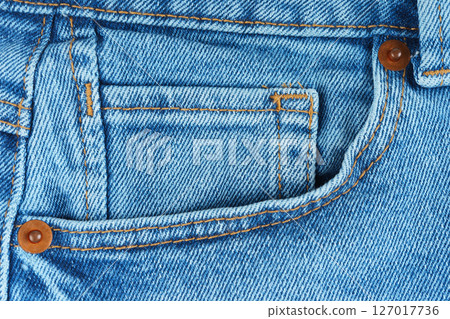 Front pocket, small pocket and metal rivets of blue jeans pants, casual wear details, background 127017736