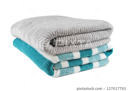 Soft fluffy striped grey and turquoise bath towels folded in stack isolated on white background 127017783