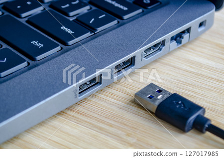 USB plugged into high speed port symbolizing convenience and cyber risk trade off 127017985