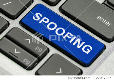 Spoofing text on keyboard showcasing threats of impersonation in digital communications 127017986