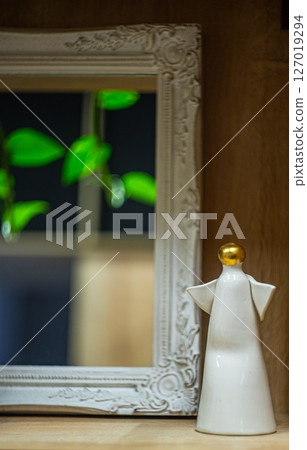 Cute angel statue in front of mirror Cute angel statue in front of mirror 127019294