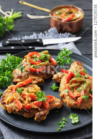 pork chops topped with bell pepper cream gravy 127019338