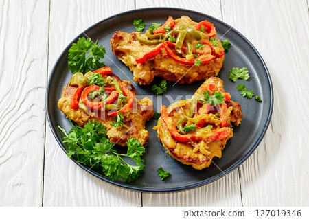 pork chops topped with bell pepper cream gravy 127019346