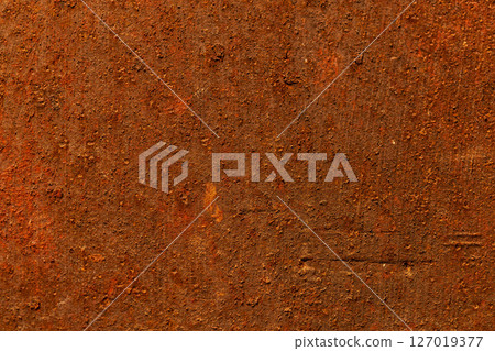 Rusty metal surface close-up, orange brown corrosion texture 127019377