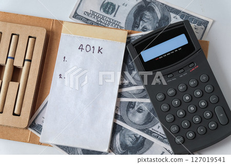 401k  Plan note with egg and Pile of US Money. 127019541