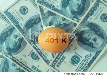 401k  Plan note on egg and Pile of US Money. 127019603
