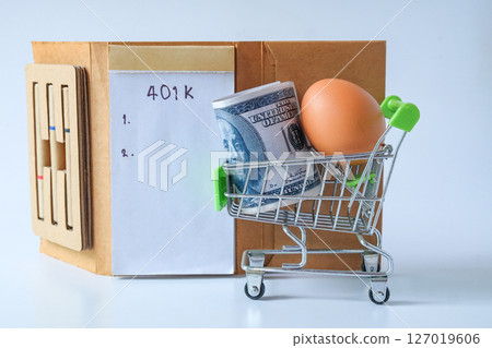 401k  Plan note with egg and Pile of US Money. 127019606