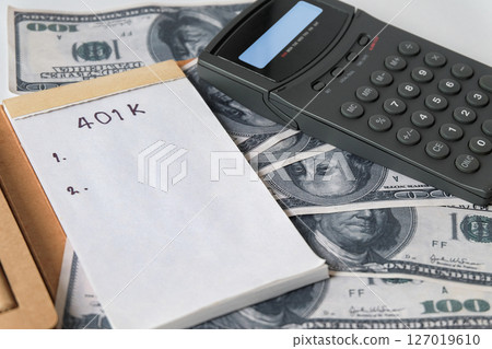 401k  Plan note with egg and Pile of US Money. 127019610