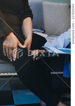 Young doctor examines senior patient's leg Young doctor examines senior patient's leg 127020161