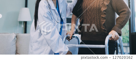 Young doctor examines senior patient's leg Young doctor examines senior patient's leg 127020162