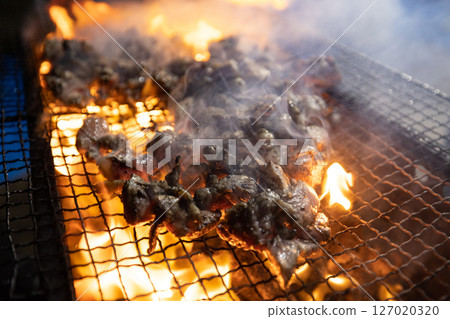 Charcoal grilling of chicken 127020320