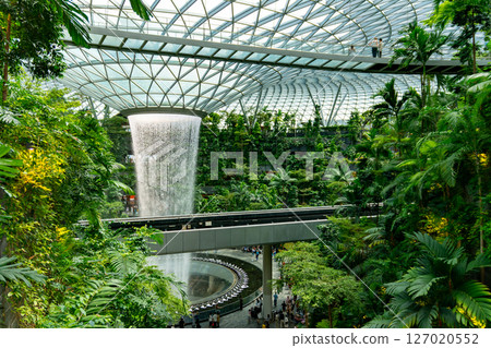 Singapore, 7 April 2025 : Parallax view of indoor Singapore rain vortex dome waterfall in rain forest Jewel Changi Airport Singapore 127020552