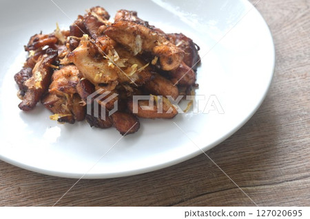 fried slice chicken meat with salt and garlic on plate fried slice chicken meat with salt and garlic on plate 127020695