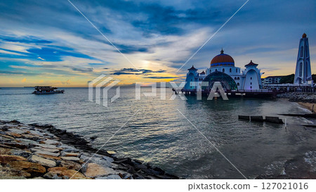Bandar Melaka, Malaysia- April 16 2025.Masjid Selat Melaka is a landmark for tourist spot in Malacca.A landmark that attracts people to view the architecture landscape.The mosque is built on the sea. 127021016