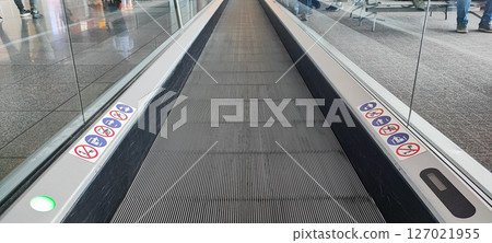 Escalator walkway at the airport. Electric moving walkway at Porto Portugal airport. Moving walkway in the airport terminal, travel concept 127021955