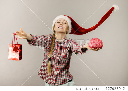 Christmas woman holding shopping bag and brain Christmas woman holding shopping bag and brain 127022042