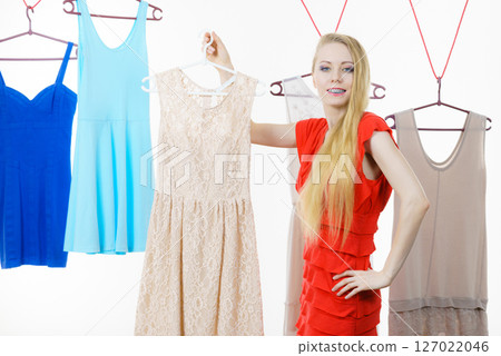 Woman choosing clothes in shop 127022046