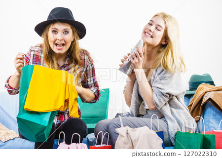 Two happy female friends after shopping 127022310
