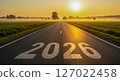2026 painted on a foggy country road at sunrise. Symbolizes a hopeful new year journey 127022458