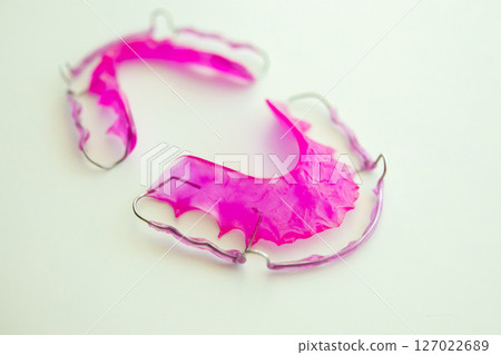 Pink acrylic dental retainer on white background Pink acrylic dental retainer on white background 127022689