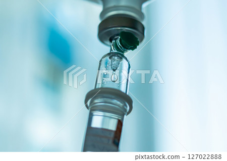 Close up medical intravenous IV drip in hospital background Close up medical intravenous IV drip in hospital background 127022888