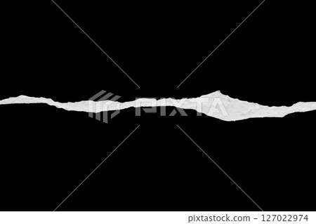 Ripped torn paper edges isolated on black background Ripped torn paper edges isolated on black background 127022974