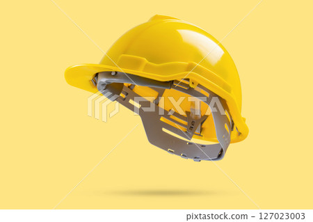 Safety construction helmet on yellow background Safety construction helmet on yellow background 127023003
