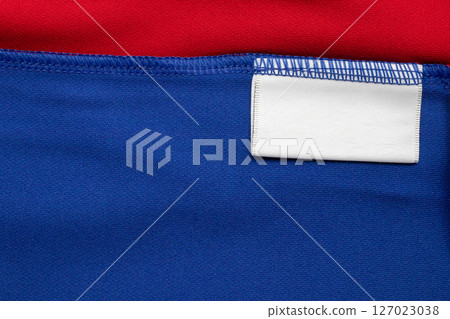 White blank laundry care clothes label on shirt fabric background 127023038
