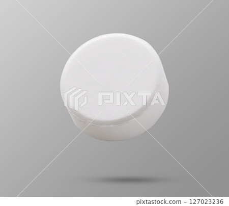 White medicine pill tablet flying on background White medicine pill tablet flying on background 127023236