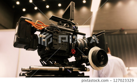 Professional cinema cameras being used in a studio or event setting.  High end gear with crew operation and behind the scenes video production in action. Camera for Live recording and broadcasting. 127023329