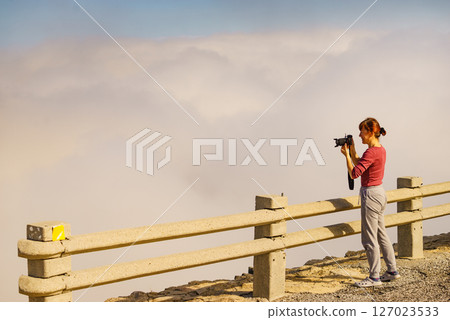 Woman with camera in mountains take travel photo Woman with camera in mountains take travel photo 127023533