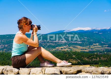 Woman take photo on mountain nature in France 127023549
