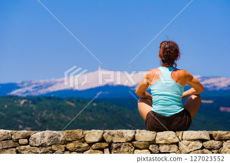 Woman enjoying mountain nature view in France Woman enjoying mountain nature view in France 127023552