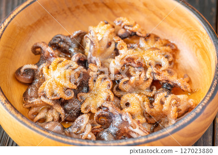 Golden Fried Garlic Octopuses Served In Rustic Wooden Bowl With Crisp Edges 127023880