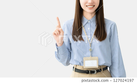 A smiling woman/businesswoman pointing with her index finger up 127024197