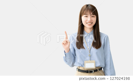 A smiling woman/businesswoman pointing with her index finger up A smiling woman/businesswoman pointing with her index finger up 127024198