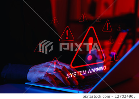 System Warning Alert and Cybersecurity Threat Concept. A person using laptop with system warning and exclamation triangles red, symbolizing cyber security alerts, system failure, and critical threats. System Warning Alert and Cybersecurity Threat Concept. A person using laptop with system warning and exclamation triangles red, symbolizing cyber security alerts, system failure, and critical threats. 127024903