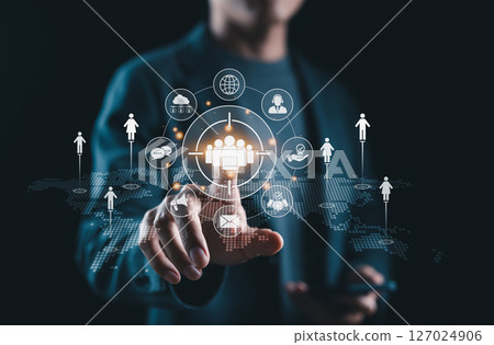 Target Audience and Digital Outreach Strategy Concept. Businessperson points at virtual interface with people icons and marketing symbols, representing audience targeting and global digital strategy. 127024906