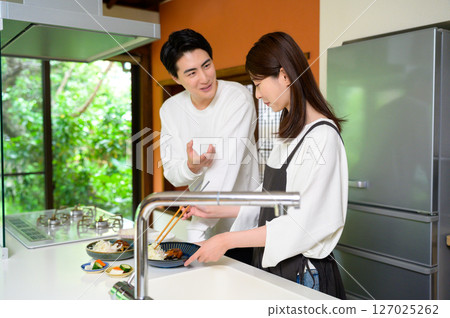 Men and women enjoying a harmonious time together while smiling and chatting 127025262