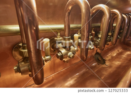 Beer brewery copper pipes taps and tanks 127025333