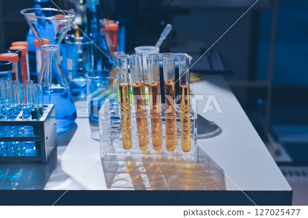 Scientist pipetting medical samples into microplate in laboratory 127025477