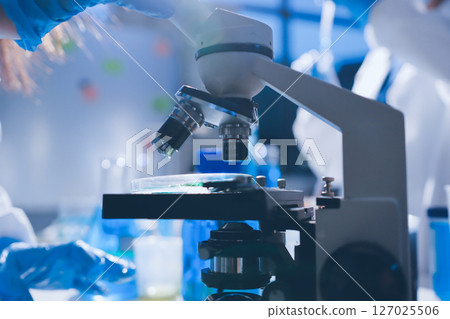 Scientist pipetting medical samples into microplate in laboratory Scientist pipetting medical samples into microplate in laboratory 127025506