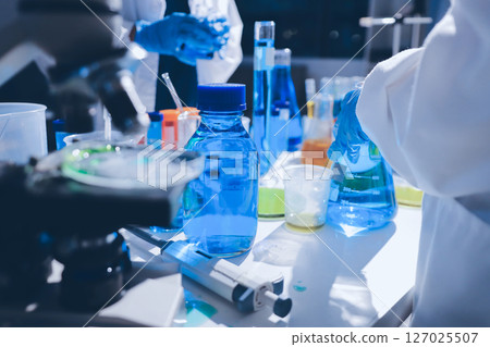 Scientist pipetting medical samples into microplate in laboratory Scientist pipetting medical samples into microplate in laboratory 127025507
