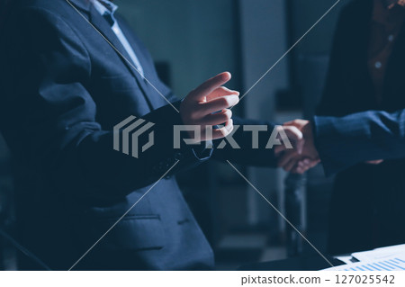Close-up of handshake of businesswoman and businessman 127025542