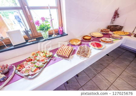 Candy bar pink wedding decorated standing of festive table with deserts, strawberry tartlet and cupcakes Candy bar pink wedding decorated standing of festive table with deserts, strawberry tartlet and cupcakes 127025676