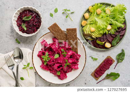 Enjoy Vibrant Beetroot Salad bursting with Fresh Greens and topped with Crunchy Crackers 127027695